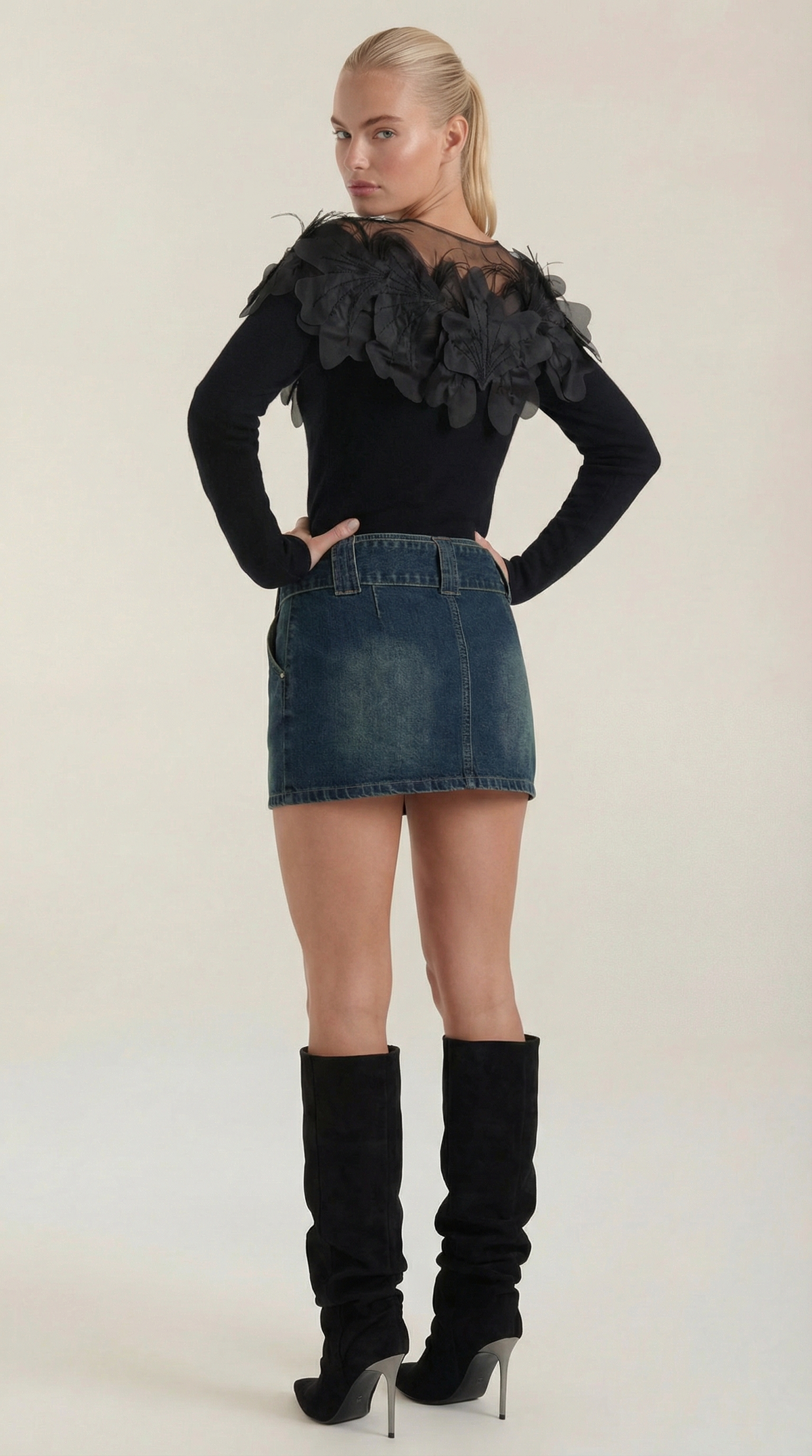 Knitted sweater with feather embellishments