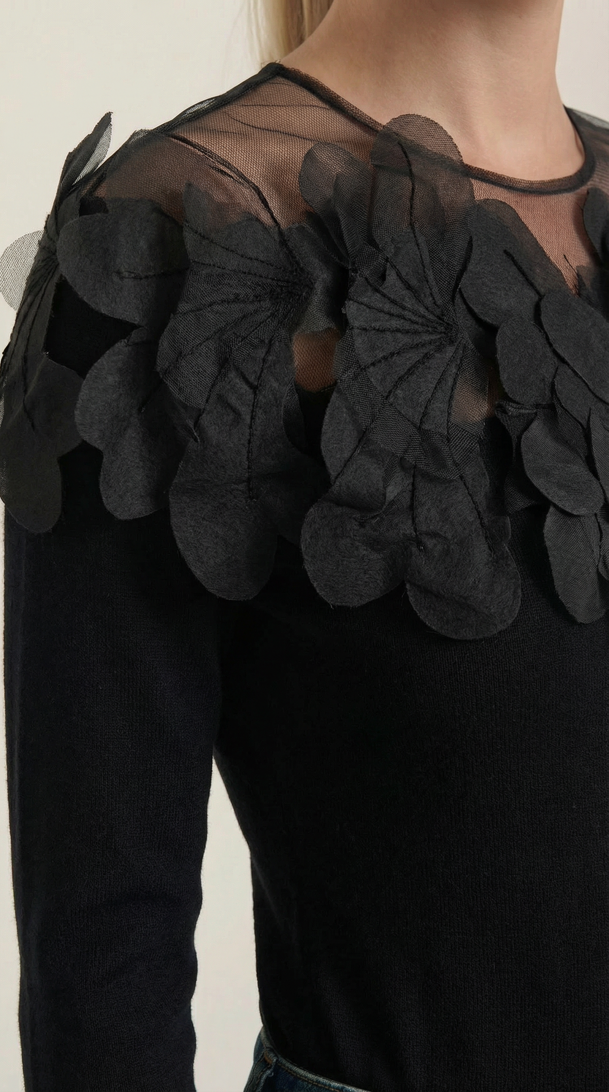 Knitted sweater with feather embellishments